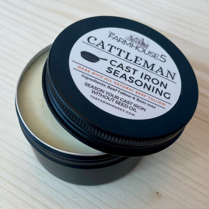 Cattleman Cast Iron Seasoning container with black lid on a light wooden surface