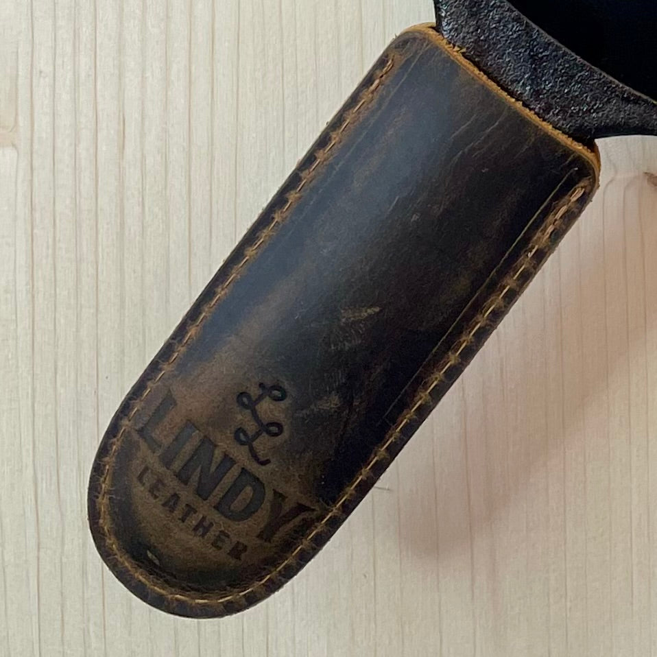 Lindy Leather Cast Iron Handle Cover on wood background